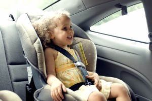 Young cute female child in back seat car set